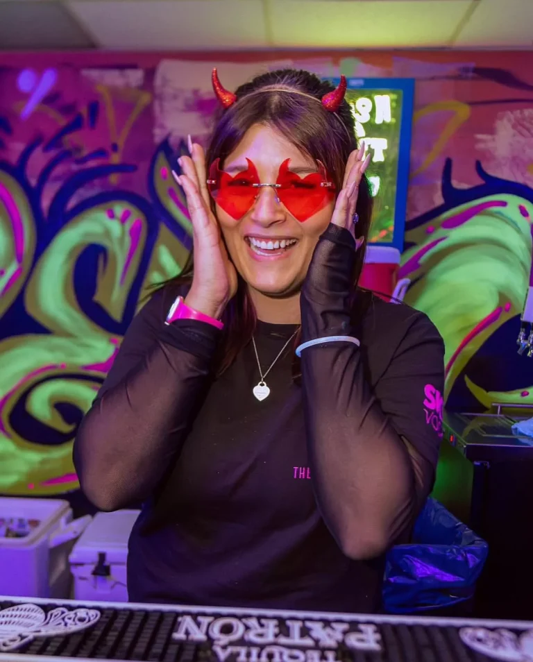 DJ wearing red heart-shaped sunglasses and headphones in the booth at a Halloween party at Clarendon Ballroom, Arlington VA