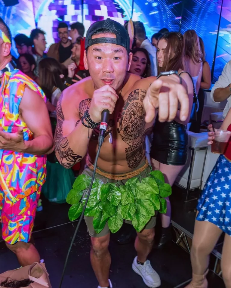 Guest in a leaf-skirt jungle costume dancing in the crowd at a Halloween party at Clarendon Ballroom